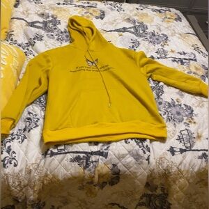 hoddie that says, “if you want to fly, give up everything that weighs you down”